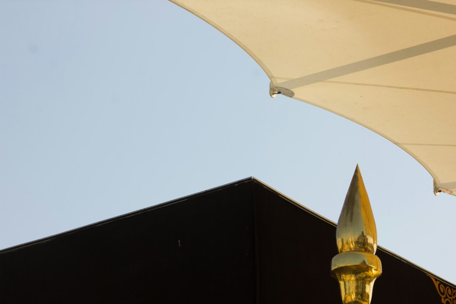 a large white umbrella sitting on top of a black building