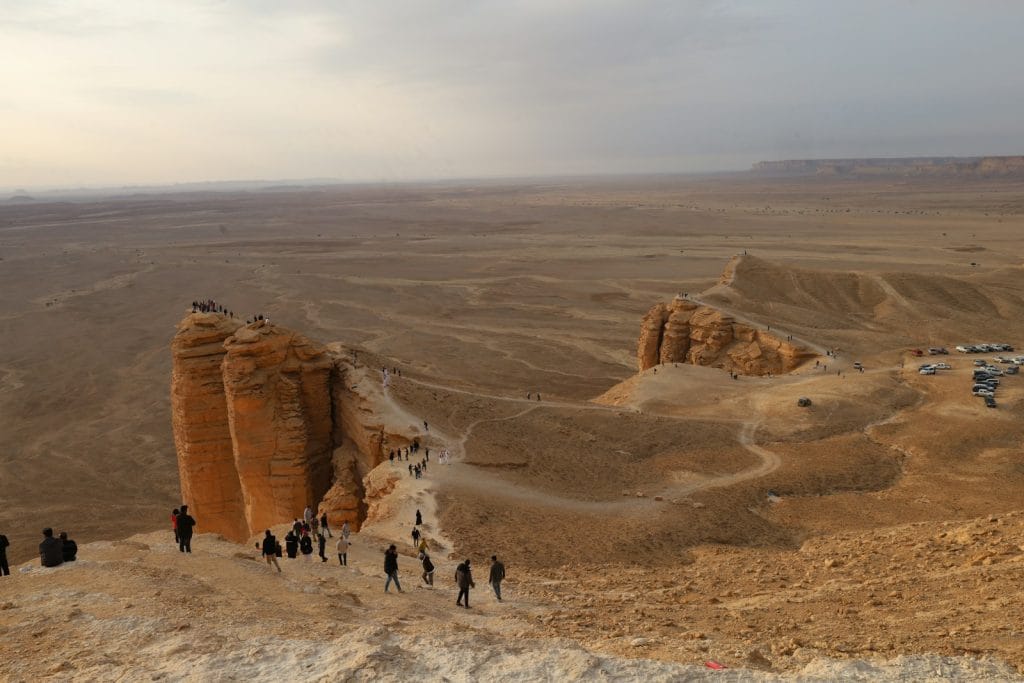 A group of people standing on top of a desert